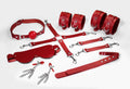 Feral Feelings BDSM Kit 7 Red, handcuffs, leg restraints, connector, mask, paddle, gag, clamps